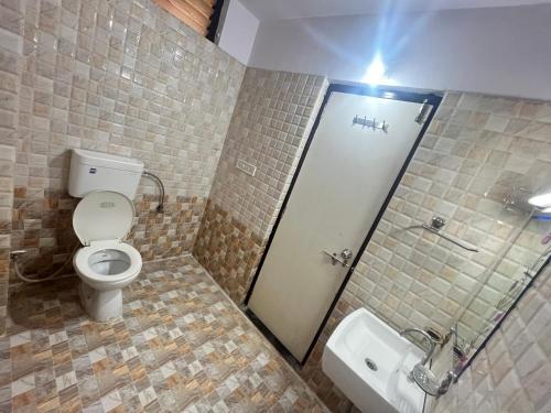 a bathroom with a toilet and a sink at Hotel Ashutosh I 300mtr from shreenathji temple I 966o9o1oo6 in Nāthdwāra