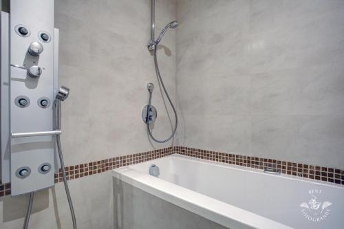 a bathroom with a bath tub and a shower at Ribera del Marlin - Sotogrande in Sotogrande