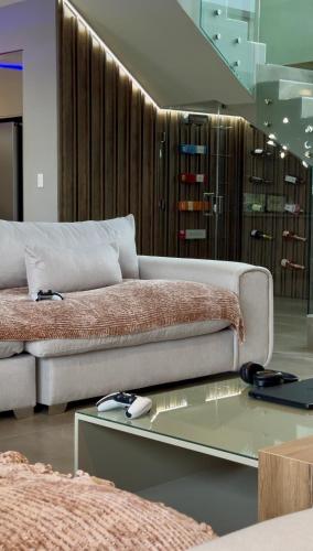 a living room with a couch and a glass table at The Views at 492 Euphoria Golf Estate in Naboomspruit