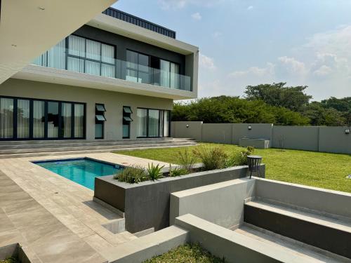 a house with a swimming pool in the yard at The Views at 492 Euphoria Golf Estate in Naboomspruit