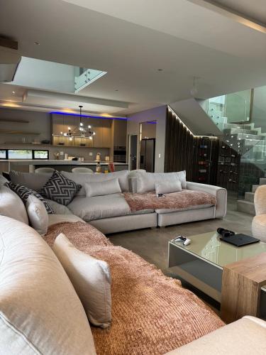 a large living room with couches and a table at The Views at 492 Euphoria Golf Estate in Naboomspruit