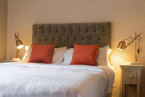 a large bed with two red pillows on it at Host & Stay - Woodroffe Arms in Hope