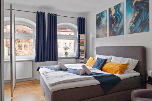 a bedroom with a large bed with blue and yellow pillows at Altstadt - Exklusive 3-Zi-Wohnung mit 90 qm und großem Balkon in Nürnberg