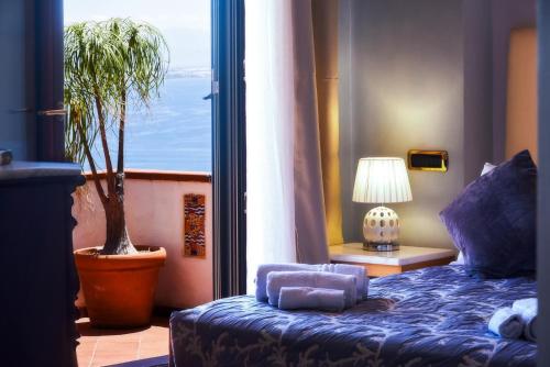a bedroom with a blue bed and a potted plant at Villa Margherita Amalfi Coast in Vietri sul Mare
