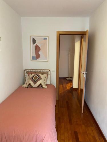 a small bedroom with a bed and a hallway at Mai&Maud Fira Apartment in Hospitalet de Llobregat