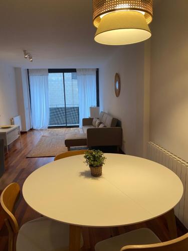 a living room with a table and a couch at Mai&Maud Fira Apartment in Hospitalet de Llobregat