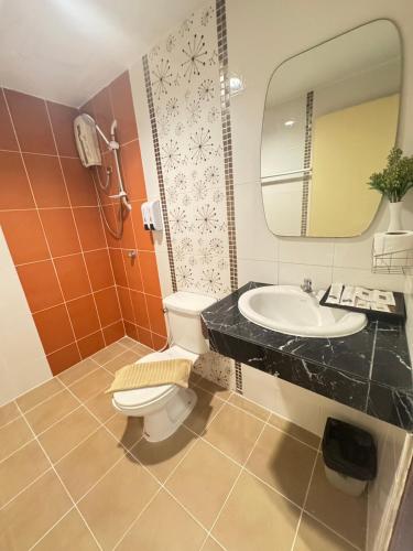 a bathroom with a sink and a toilet and a mirror at Bensri residence pattaya in Pattaya South
