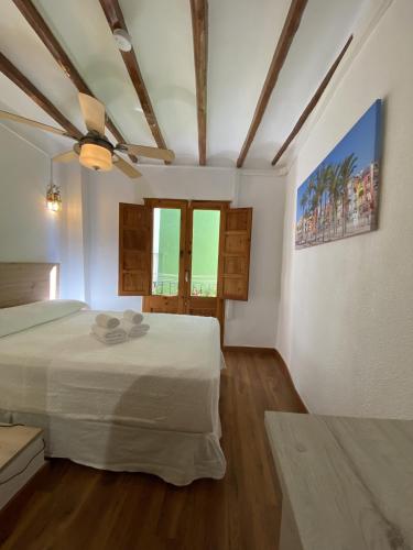 En eller flere senge i et værelse på FRAY POSIDONIO HappyVila