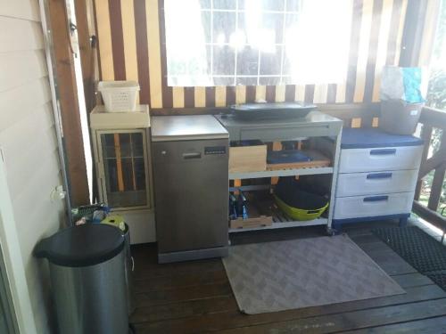 a small kitchen with a counter and a sink at Mobil home 557 in Gastes