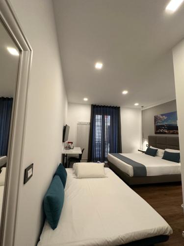 a hotel room with two beds and azeb sidx sidx sidx at Sweet Rooms in La Spezia
