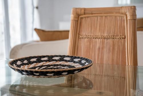 a bowl sitting on a glass table next to a chair at Cavos Paros Private Pool Oasis in Aliki