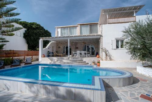 a villa with a swimming pool and a house at Cavos Paros Private Pool Oasis in Aliki