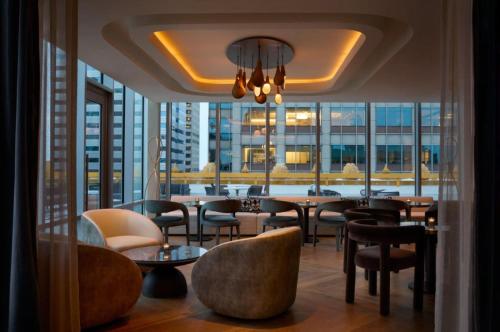 a restaurant with tables and chairs and a large window at InterContinental Indianapolis by IHG in Indianapolis