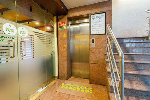 an elevator in a building with a escalator at Treebo Kings Orchid in Bengaluru