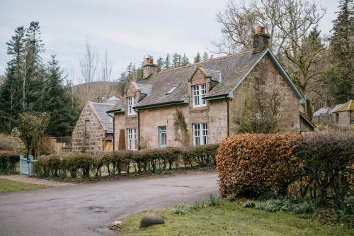 an old stone house with a road in front of it at Gamekeeper's Cottage in Banchory