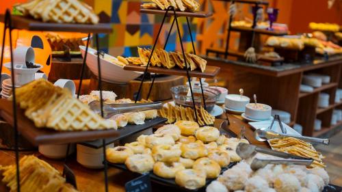 a buffet of pastries and breads on display in a bakery at Hot Beach Resort in Olímpia