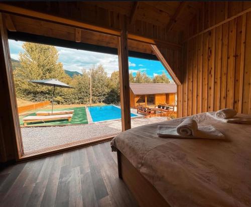 a bedroom with a large window looking out at a pool at Hellena in Sarajevo