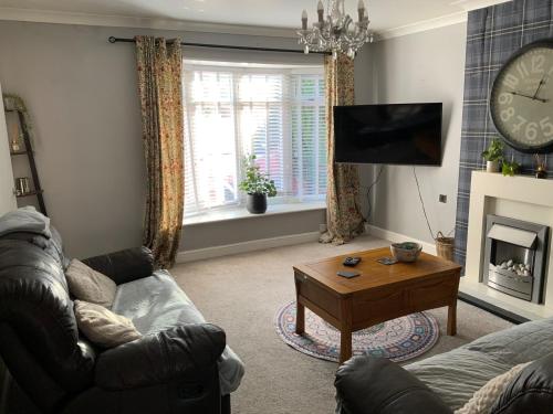 a living room with a couch and a coffee table at 3 bed semi detached house near Stourbridge in Stourbridge