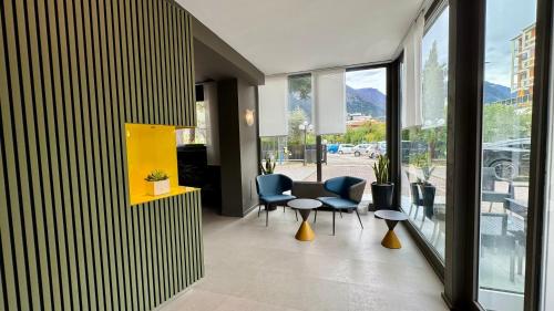 a lobby with chairs and a table in a building at Hotel Royal in Riva del Garda