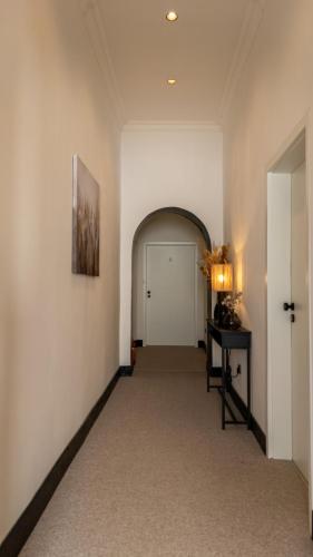an empty hallway with a white door and a table at Modern Stay I Cosy & Central Apartments in Koblenz