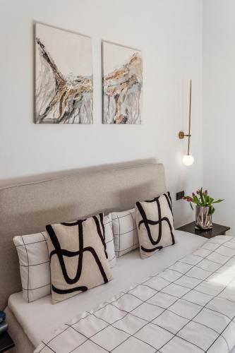 a white couch with three pictures on the wall at Modern Stay I Cosy & Central Apartments in Koblenz