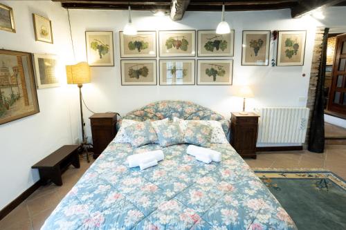 a bedroom with a bed with two pillows on it at GiuMa Tuscany Historic Country House with Patio near Saturnia Spa in Montemerano