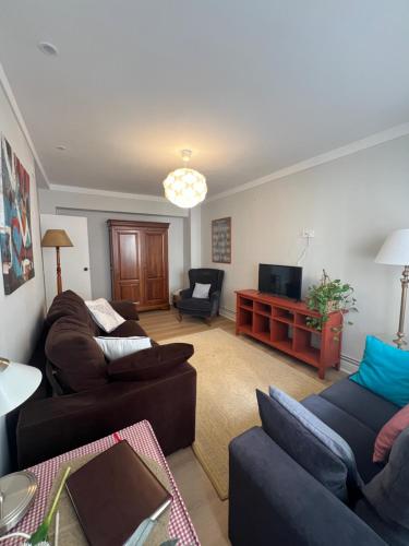 a living room with two couches and a television at Goieta in Bilbao