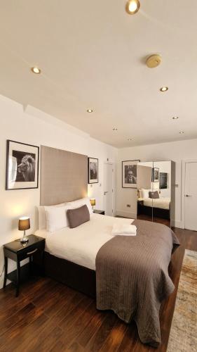 a bedroom with a large bed in a room at Clockwork Stay London in London