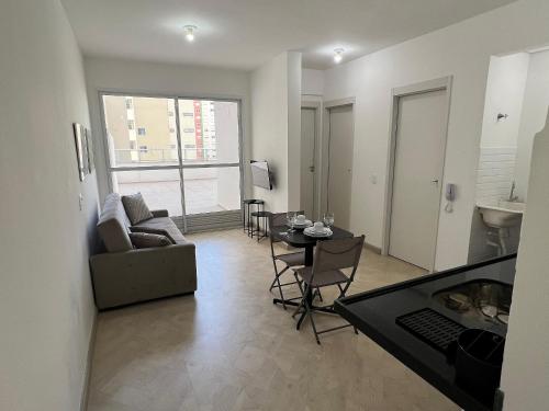 a living room with a couch and a table at LK Centro 6 in Belo Horizonte