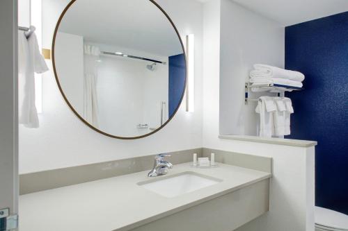 a bathroom with a sink and a mirror at Fairfield by Marriott Inn and Suites Boulder Broomfield Interlocken in Broomfield