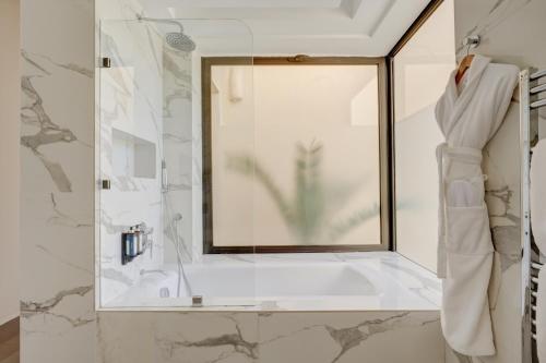a bathroom with a shower with a glass window at Sirayane Boutique Hotel & Spa Marrakech in Marrakesh