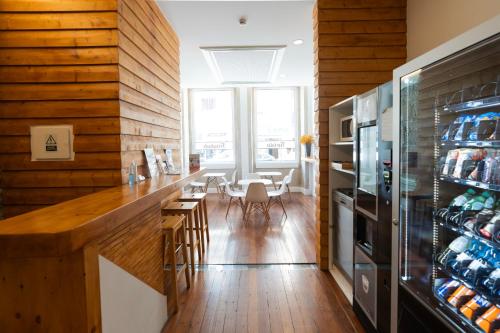 a kitchen with wooden walls and a dining room at Turista Da Trindade in Porto