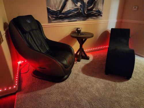 a chair and a speaker in a room with lights at Frisky Adult Play Place - Stay Fri & Sat get Sunday Free! "Massages Available" in Charlotte