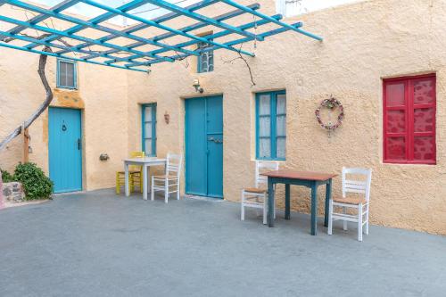 a group of tables and chairs in front of a building at Caveland in Karterados