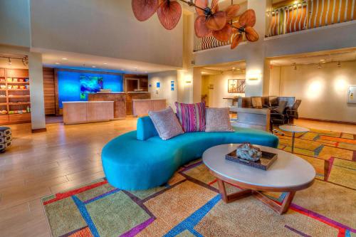 a living room with a blue couch and a table at Fairfield Inn & Suites by Marriott Destin in Destin