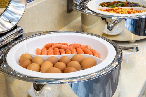 a plate of eggs and carrots and plates of food at LanOu hotel in Chengdu