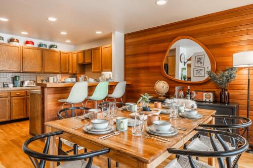 a dining room with a wooden table and chairs at Cedar and Snow in Mammoth Lakes