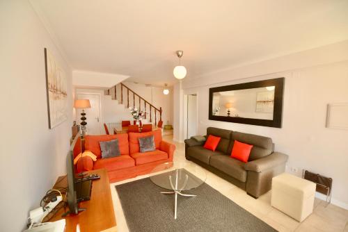 a living room with two couches and a television at Bay in São Martinho do Porto