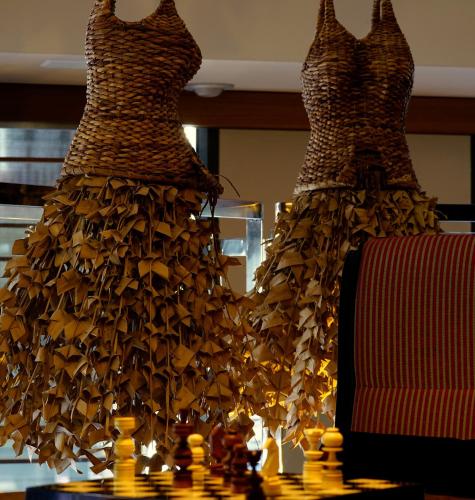 two dresses are on display on a table at Hotel Villa Emilia in Barcelona