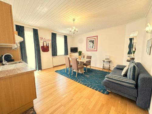 a living room with a couch and a table at Gästehaus Gertrude in Velden am Wörthersee