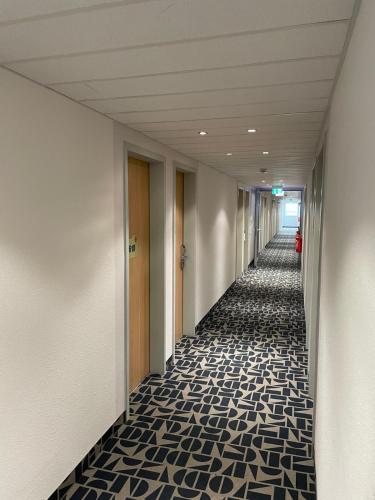 a hallway of an office building with ailed floor at Ibis budget Koeln Messe in Cologne