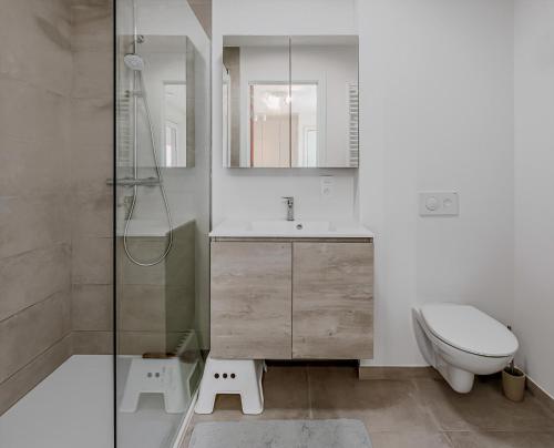 a bathroom with a toilet and a sink and a shower at Villa Zephir O3O5G 221 in Nieuwpoort