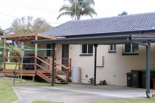 a house being constructed with a porch and a deck at Leo's Beach Haven in Batehaven