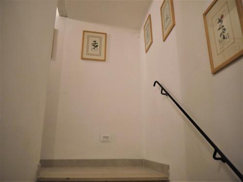 a stairwell with a railing and pictures on the wall at Casa Marzia in Montevarchi