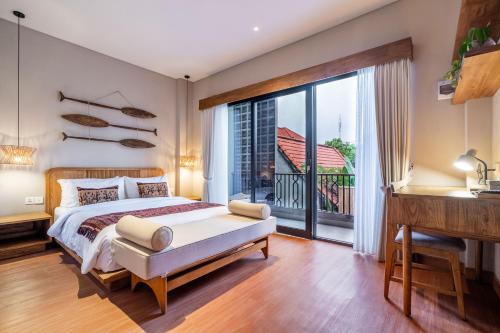 a bedroom with a bed and a large window at Arusa Home Bali - Luxury Private Suites Canggu in Canggu