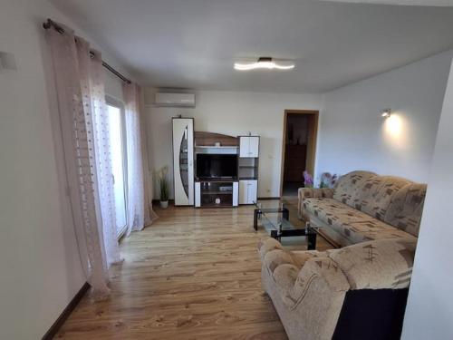 a living room with two couches and a living room with at Holiday Home Iva & Luca in Stankovci