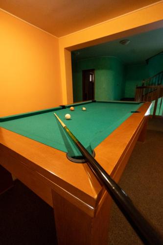 a pool table with billiard balls on top of it at Chata Guľka Kováčová in Kováčová