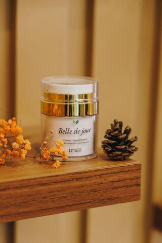 a jar of candle sitting on a wooden shelf at Hotel Corsica & Spa Serena in Calvi