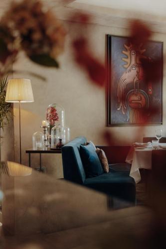 a living room with a blue couch and a table at Sirayane Boutique Hotel & Spa Marrakech in Marrakesh