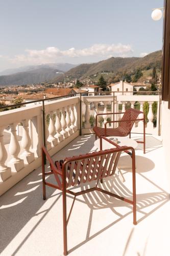 two benches sitting on a balcony overlooking a city at LA CASA DI LAURA in Valdobbiadene